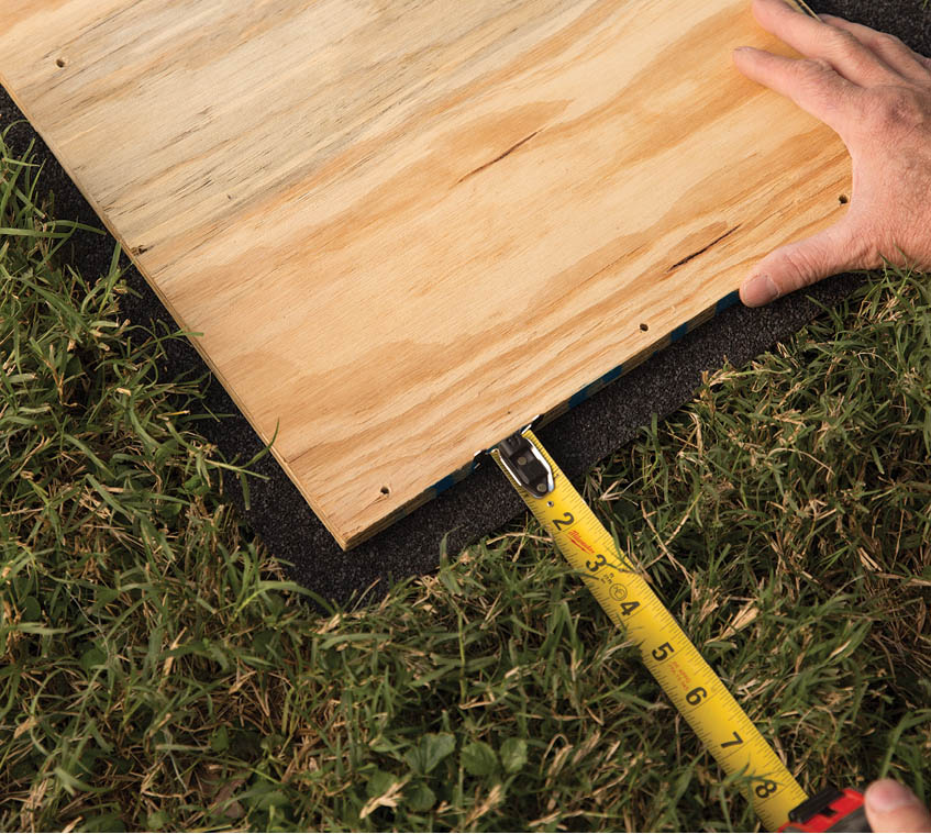 Measuring a piece of roofing.