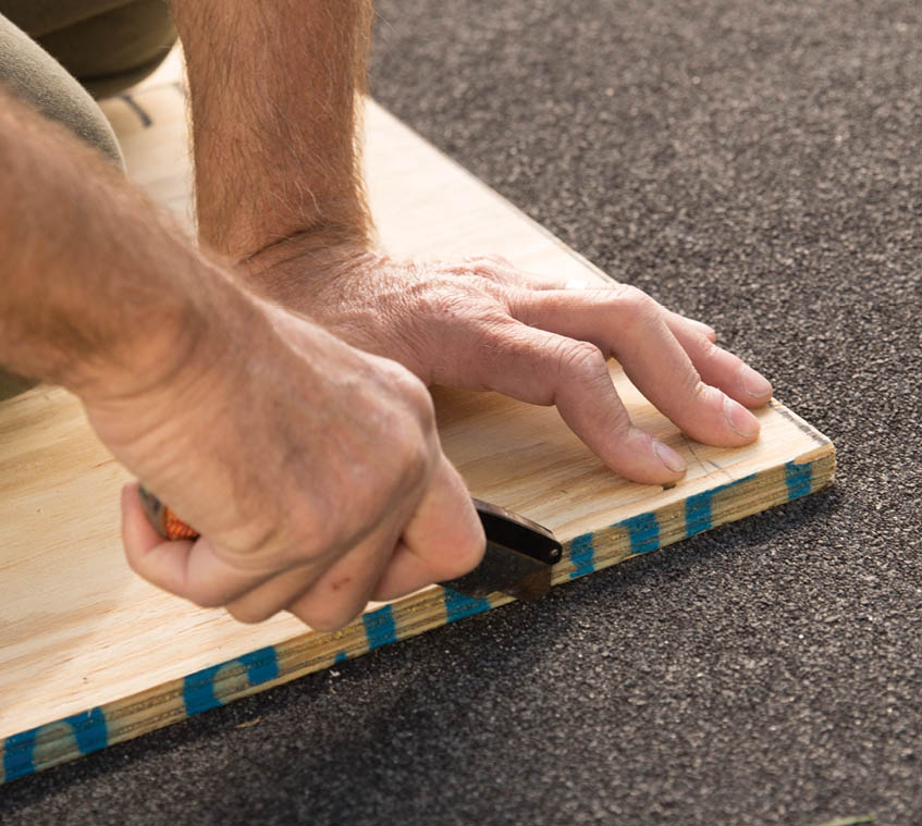 Cutting out a section of roofing.