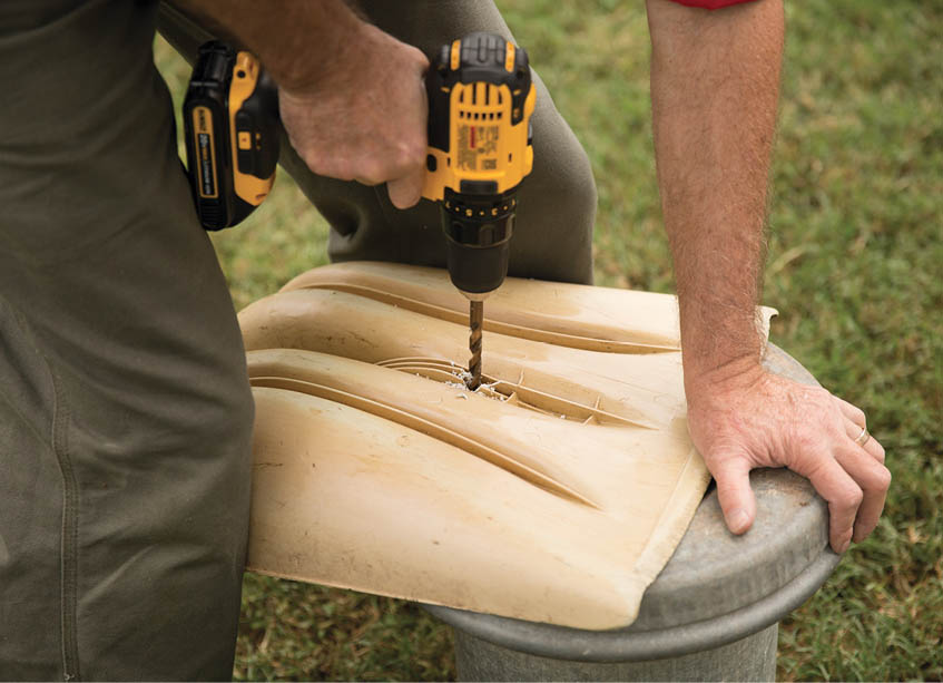 Drilling a hole into the back of a shovel.