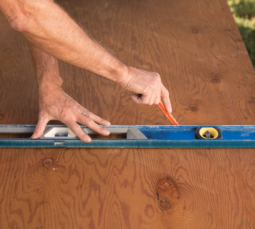 Marking the plywood overhang.