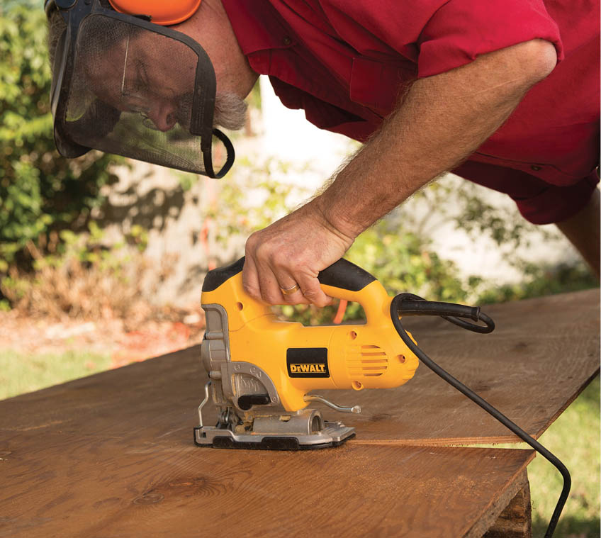 Cutting off the plywood overhang.