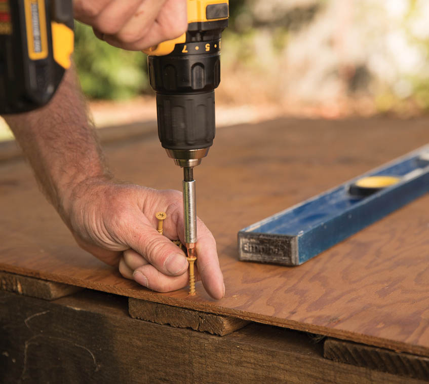 Drilling in screws in the plywood.