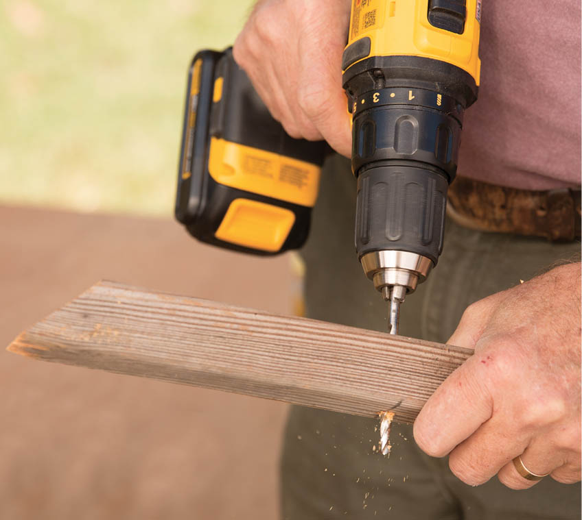 Drilling a hole through the pivot arm.