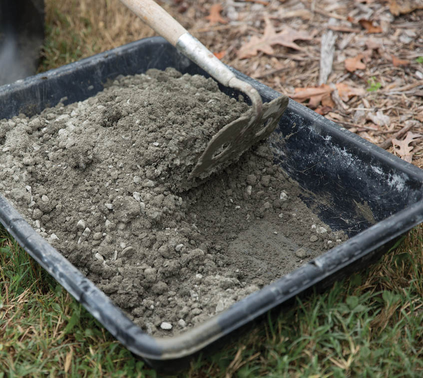 Stirring the concrete mix with a hoe.