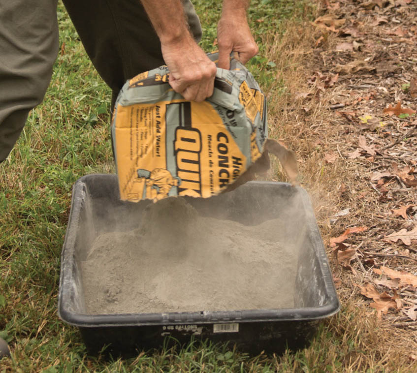 Dumping out the concrete mix into the tray.