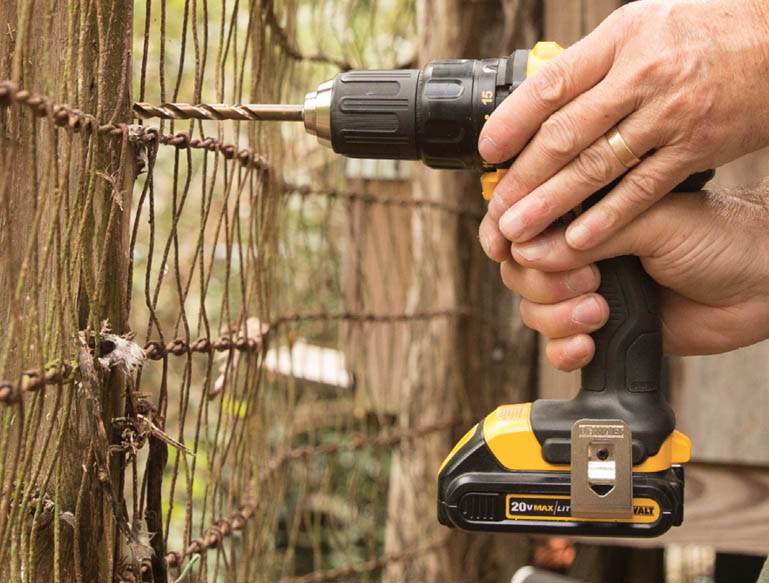 Drilling into a fence post.