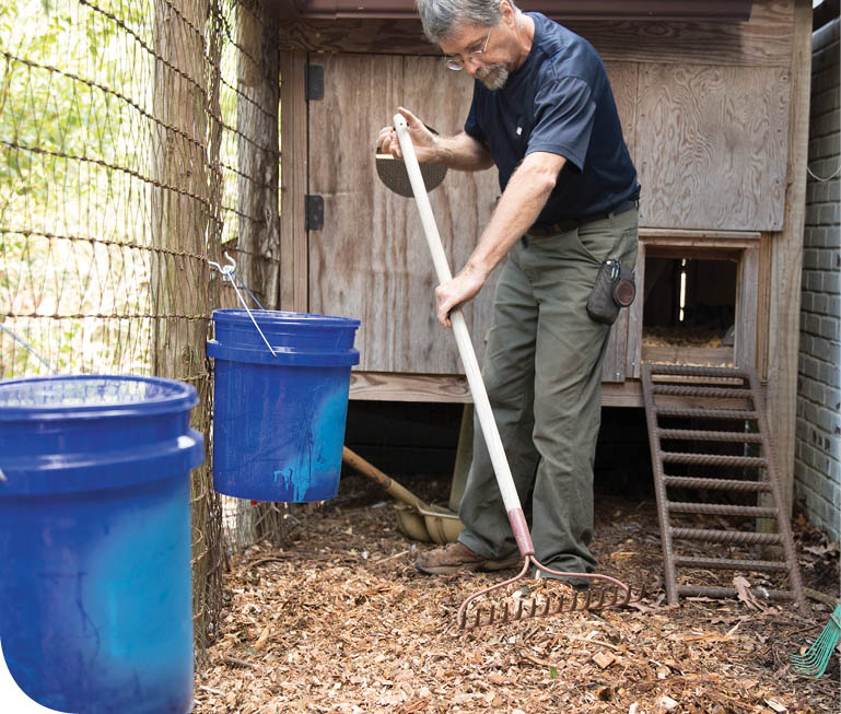 Spreading out the wood chips with a rake.