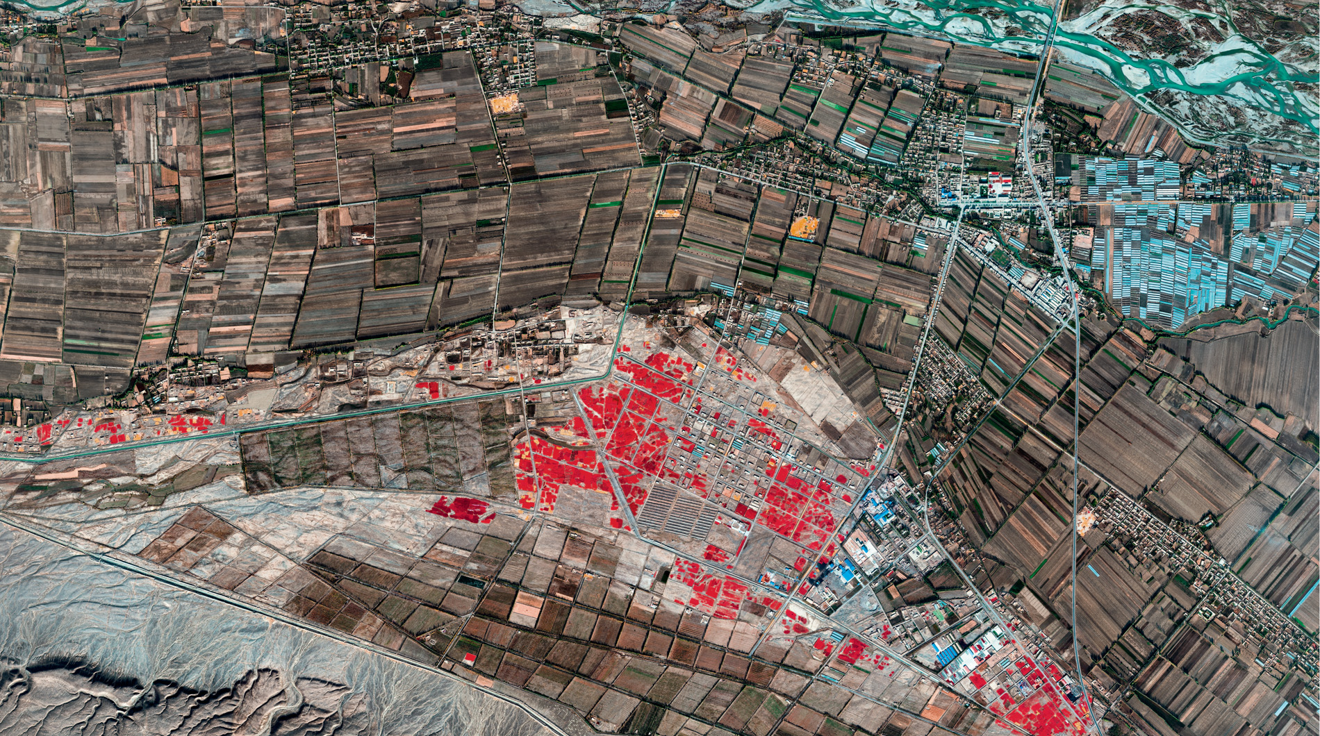 Farmers dry red chillies under the Sun near a town in the Gobi Desert. Satellite imagery courtesy of © 2018 DigitalGlobe, a Maxar company.