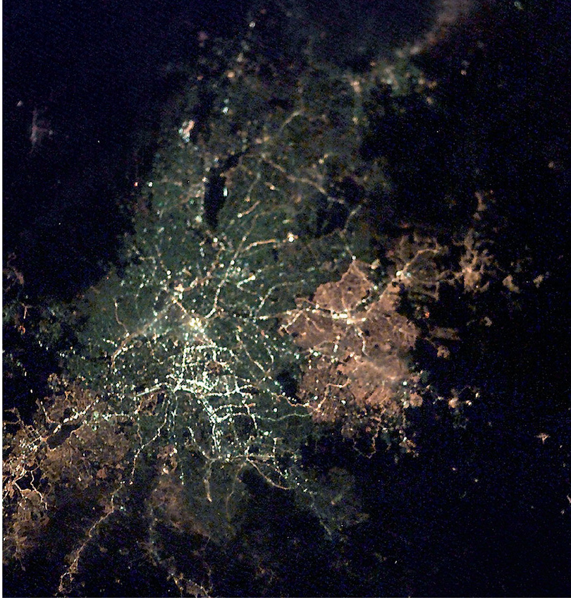 São Paulo at night as seen from the International Space Station. It is South America’s largest city with 17 million people. The different colours – pink, white and grey – show different generations of streetlights. © NASA