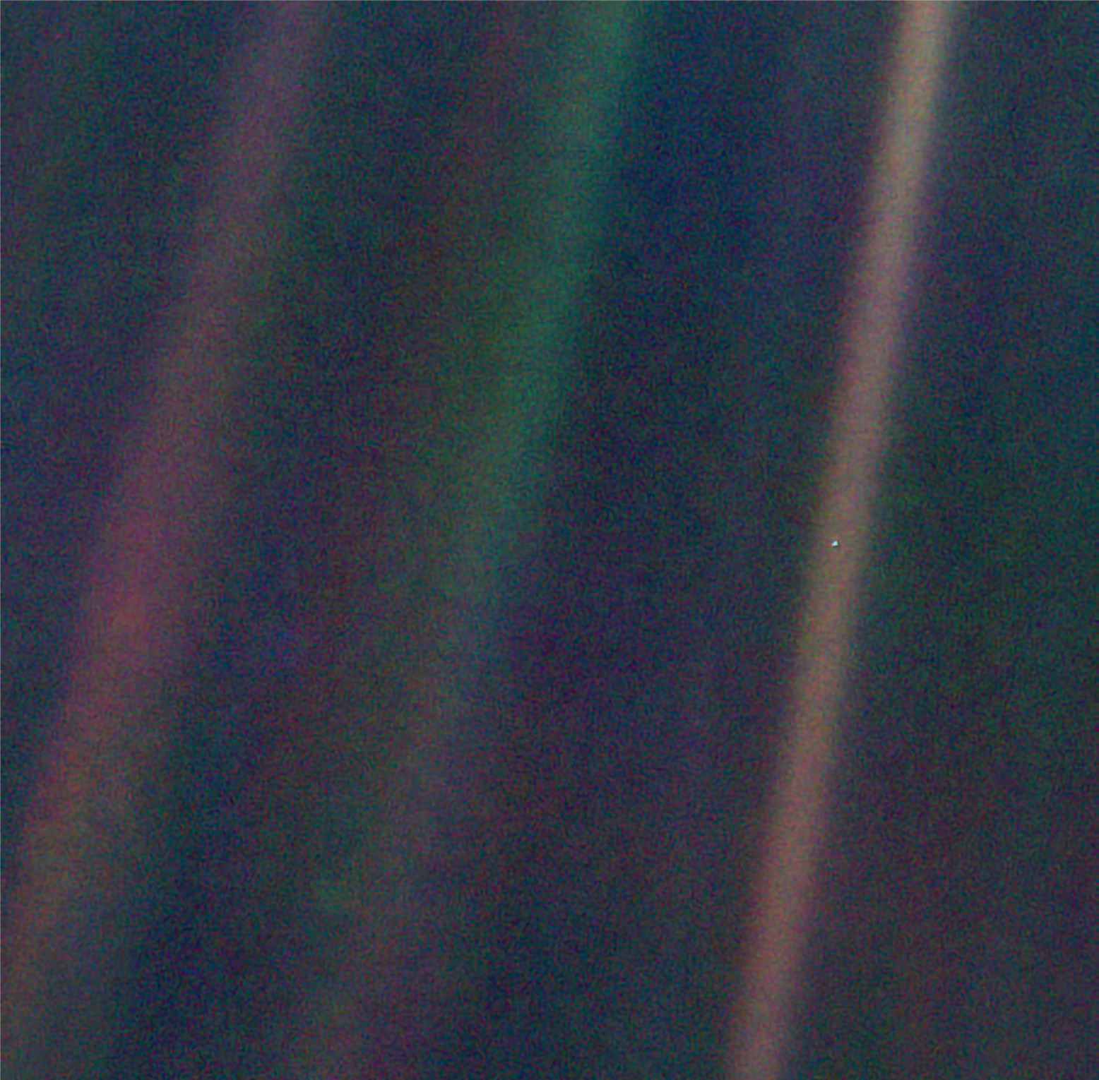 Look carefully and you can see the Earth as a tiny ‘pale blue dot’. It is just visible in the lightest band of the Sun’s rays reflected in the camera. The picture was taken from Voyager 1, when close to the edge of the Solar System, about 6 billion kilometres from home. © NASA/JPL