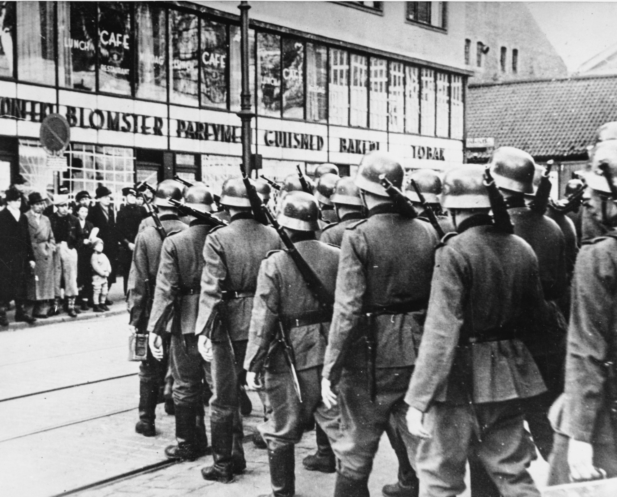 Oslo residents watch as German troops march into the city in April 1940.