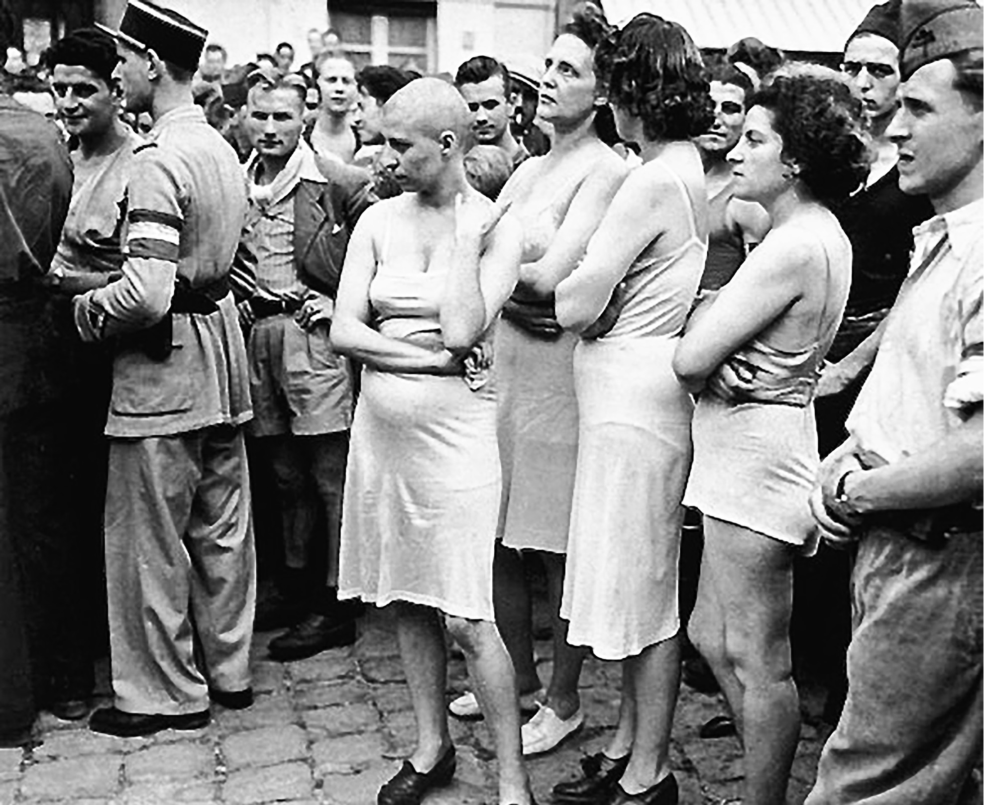 A hostile crowd surrounds Frenchwomen accused of sexual involvement with Germans. Stripped down to their undergarments, they likely all suffered the fate of the woman on the left—having their heads shaven.