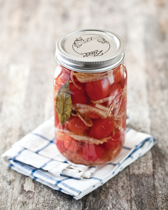 A mason jar filled with pickled cherry tomatoes