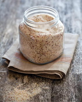 A glass jar filled with seasoned breadcrumbs