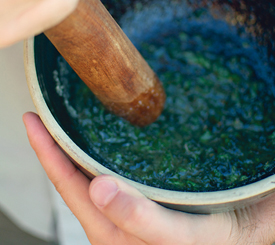 crushing mint leaves with a pestle