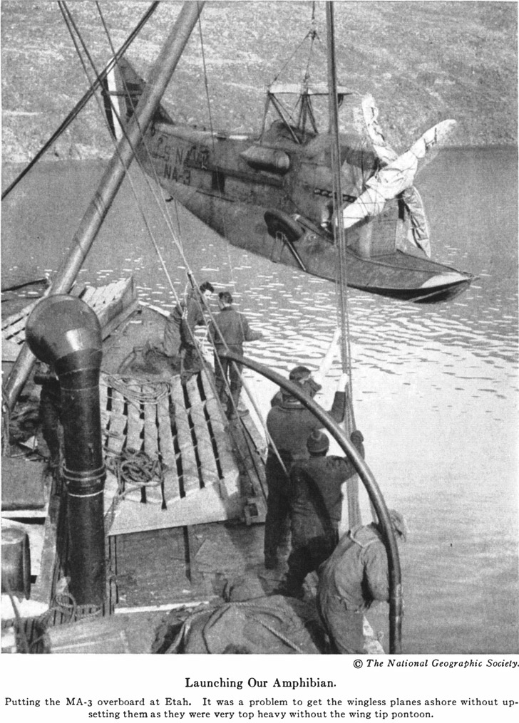 © The National Geographic Society. Launching Our Amphibian. Putting the MA-3 overboard at Etah. It was a problem to get the wingless planes ashore without upsetting them as they were very top heavy without the wing tip pontoon.