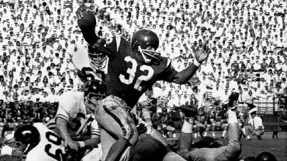 OJ Simpson breaking a tackle in a 1968 college game