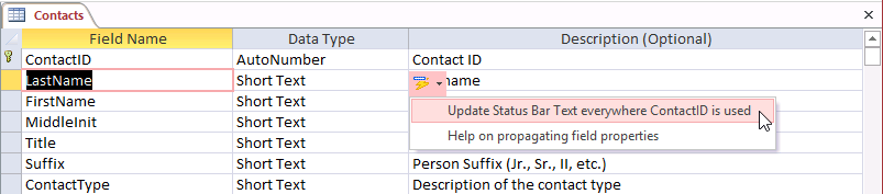 A screen shot of the Contacts table open in Design view. A button is shown just below the new description entered for the ContactID field. Author has selected the first option to update the status bar text.