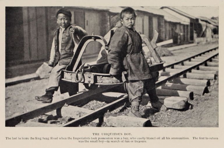 THE UBIQUITOUS BOY. The last to leave the Sing Seng Road when the Imperialists took possession was a boy, who coolly blazed off all his ammunition. The first to return was the small boy--in search of fun or treasure.