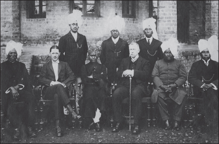 Maharaja Churachand with his Durbar Members and Nobles. Standing (from the left): Durbar Member Nongmaithem Shyamacharan, Ningthoujam Gulap, Durbar Member Sougaijam Bhubonsingh. Seated (from left): Sana Thangkokpa, Mr. J.C. Higgins, Maharaja Churachand, unidentified British officer, Older Brother Raja Dumbrasingh, Durbar Member Sougaijam Ibungochouba.