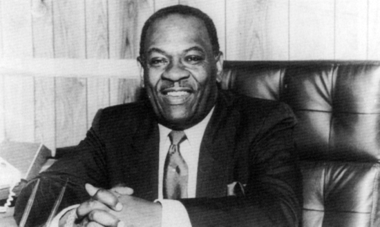 A photo of Reverend Lawrence Curtis Roberts seated at his desk.