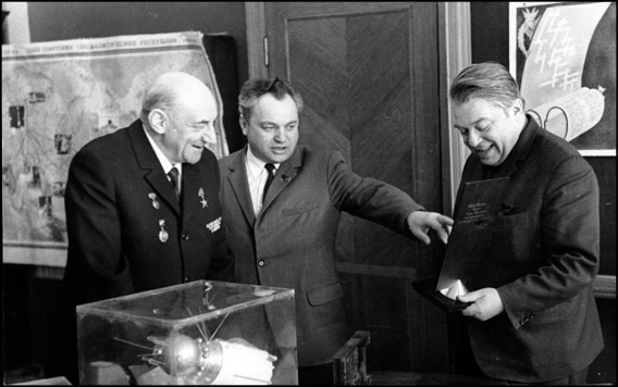 Shown here are Chief Designer Viktor Makeyev (center) and Ye. N. Rabinovich congratulating Chertok (left) on his 60th birthday in 1972.