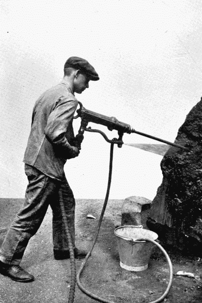 By permission of The Mining Engineering Co., Ltd., Sheffield Pneumatic Hammer Drill This tool is used by miners for making holes in hard rock, preliminary to blasting. Note the spray of water, which prevents the stone dust rising and getting into the miner's lungs.—See p. 220