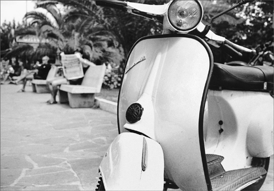 A Vespa on a stone street