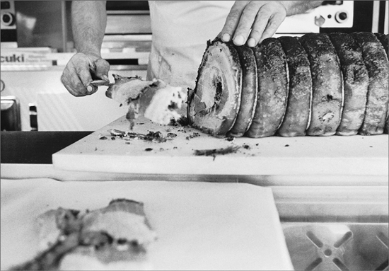 A man slicing cured meat