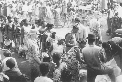 Congolese refugees uprooted from their homes by fighting in Katanga Province wait for water at a refugee camp in September 1961. (UN Photo 71906)