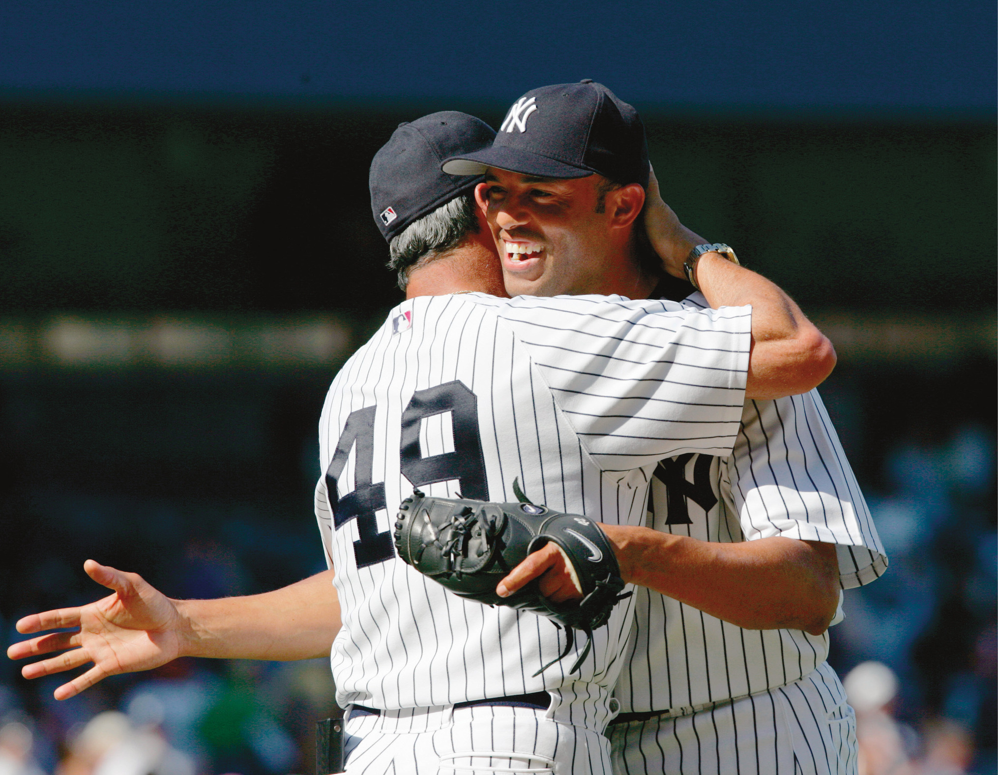 UNITED STATES - JULY 16:  New York Yankees' closer Mariano Rivera is all smiles gets a hug from pitching coach Ron Guidry, congratulating him on his 400th career save. The Yanks beat the Chicago White Sox, 6-4, at Yankee Stadium.  (Photo by Linda Cataffo/NY Daily News Archive via Getty Images)