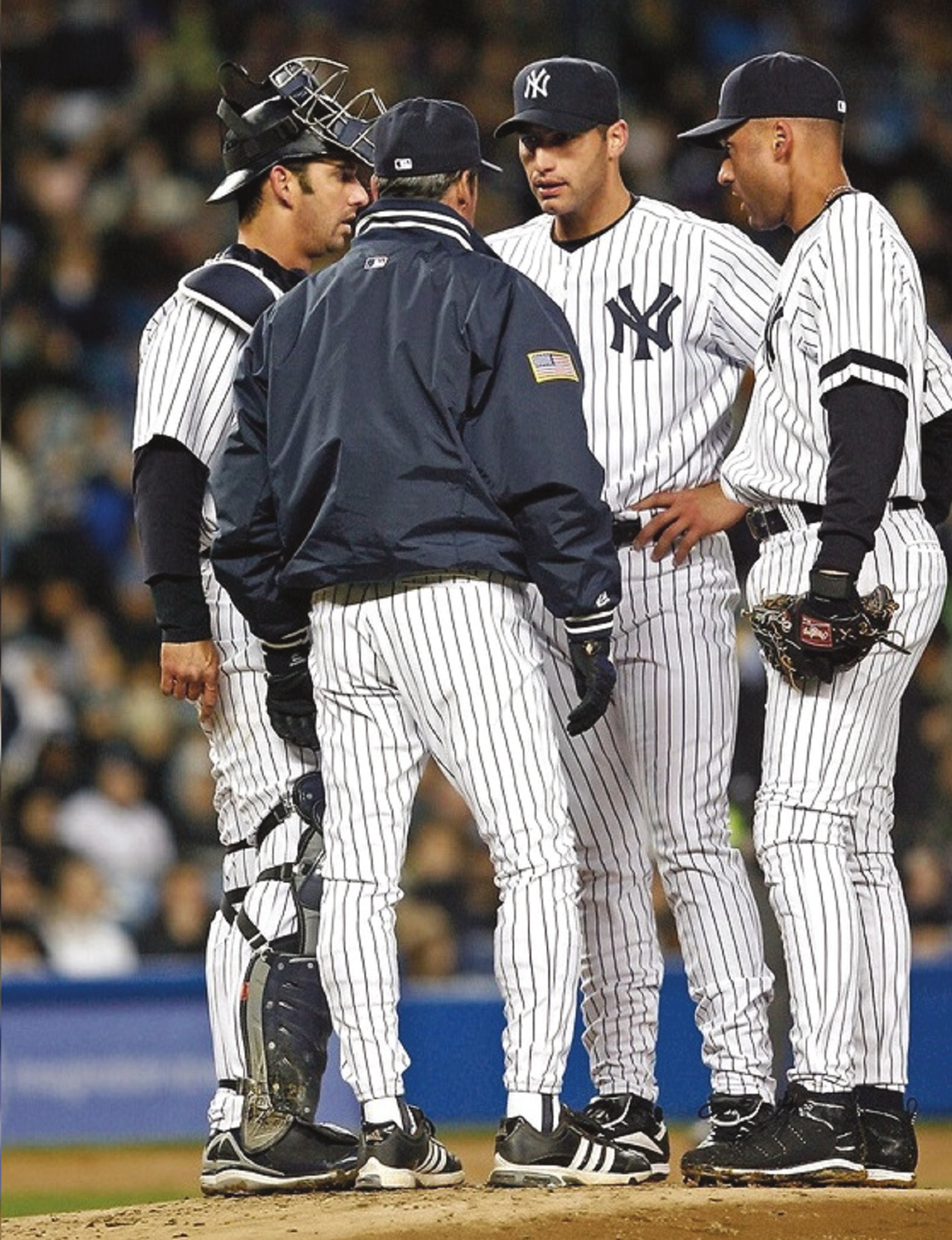 A quick conference on the mound with Andy Pettitte, along with Derek Jeter and catcher Jorge Posada.  (New York Yankees)