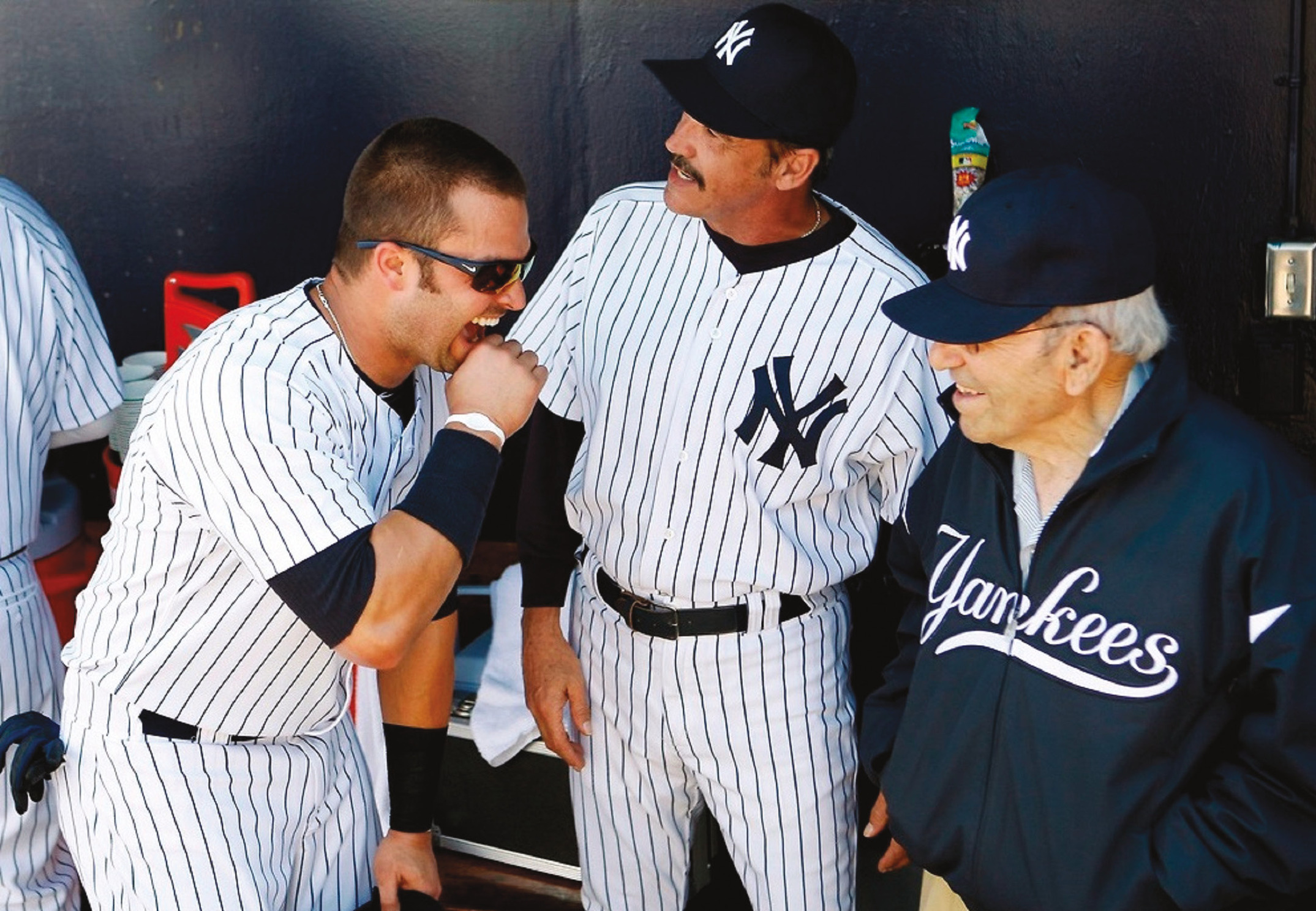 In the dugout in spring training, after all-time great Yogi Berra gave Nick Swisher some hitting advice.  (New York Yankees)