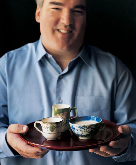 Scott holding a tray of soups in delicate cups