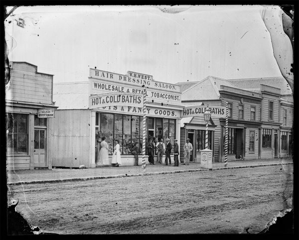 Street photo showing W.H. West’s Saloon and Tobacconist