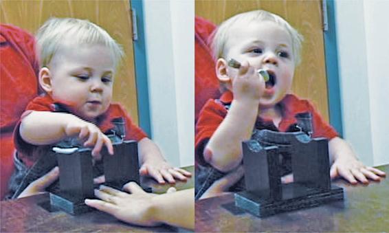 In the photo on the left, the baby is grasping a spoon pointed to the left using his right hand. In the photo on the right, he is trying to get the spoon to his mouth. Both photos show the awkwardness of using the right hand when the apparatus is set up for left-hand use.