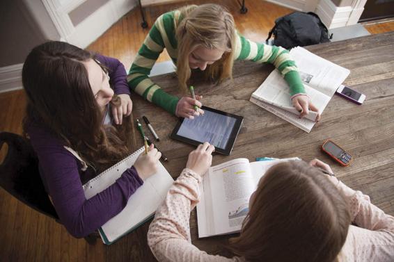 Photo of three adolescents in a study group.