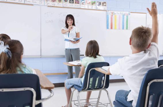 Photo of a teacher calling on a boy to answer a question in math class.