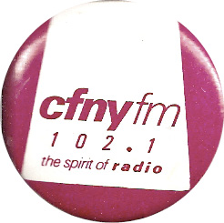 A burgundy and white pinback button that reads 'CFNYFM 102.1.'