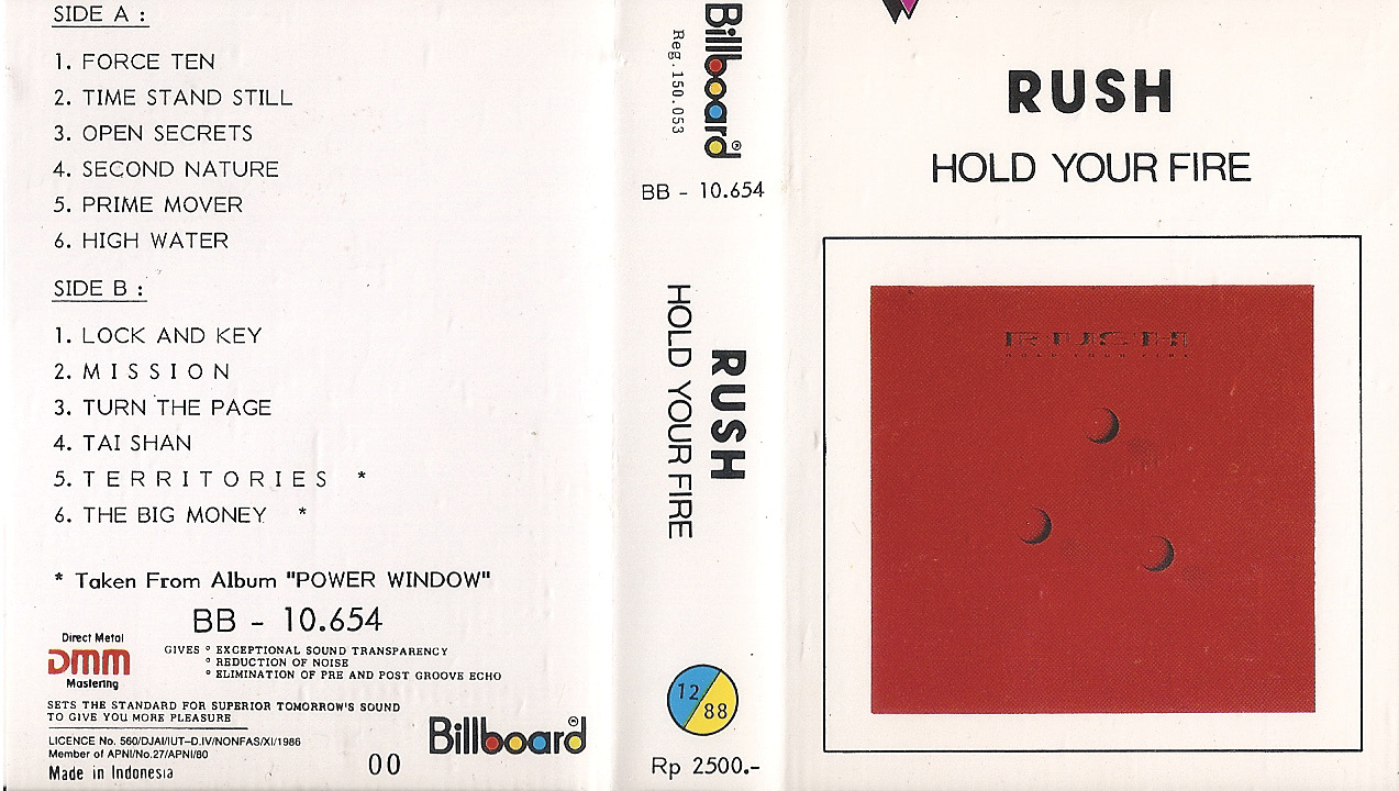 A white cassette J-card featuring the Hold Your Fire album cover on the front. The back of the cassette J-card lists all the songs available on Side A and Side B of the album.