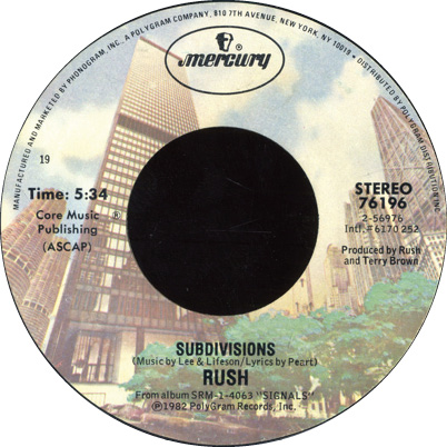 The record label for Mercury Records' 'Subdivisions' single. It features a desaturated ground-up view of office buildings and nearby foliage as the background for the label.