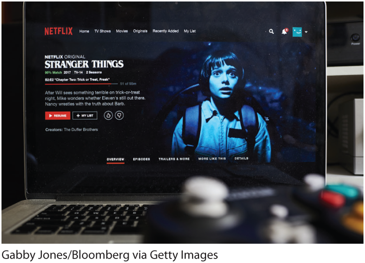 A photo shows a laptop computer displaying the home screen for the Netflix original series, Stranger Things.