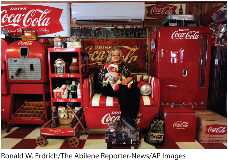 A photo of a senior woman sitting in an armchair at a Coca-Cola factory. 