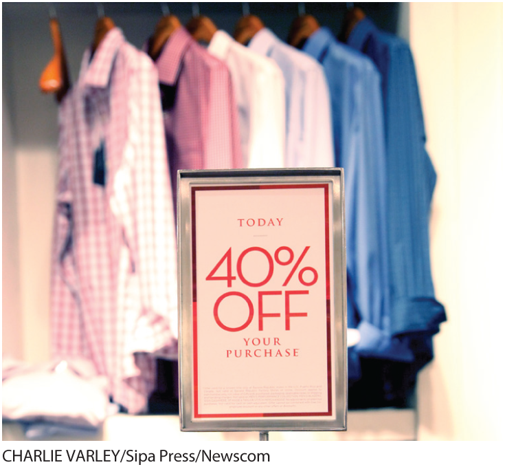 A photo shows shirts hung on a display rack and a small board that reads, Today 40 percent off your purchase.