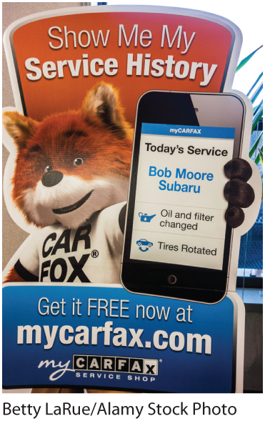 A photo shows an advertisement board for mycarfax dot com. Text in the board reads Show me my service history. Get it free now at mycarfax dot com.