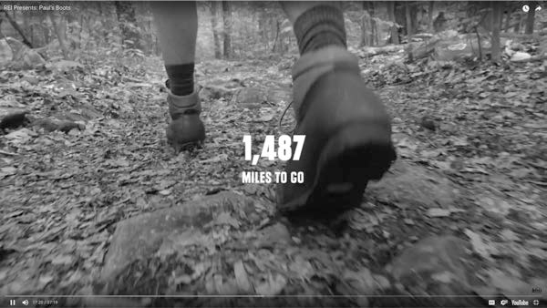 A screenshot shows a YouTube documentary titled REI Presents: Pauls Boots with a person walking and 1,487 miles to go mentioned at the center.