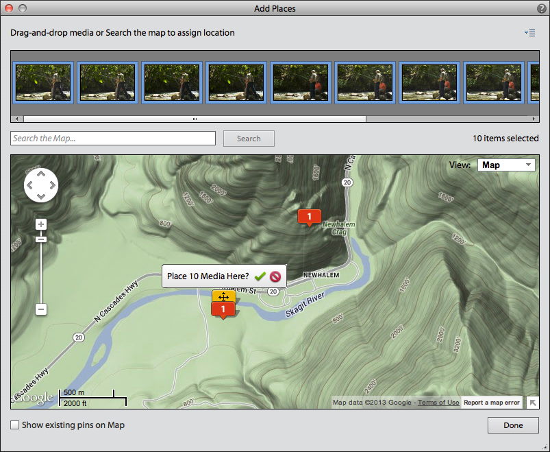 <strong>Figure 33:</strong> Drag and drop photos to a location pin in Photoshop Elements.