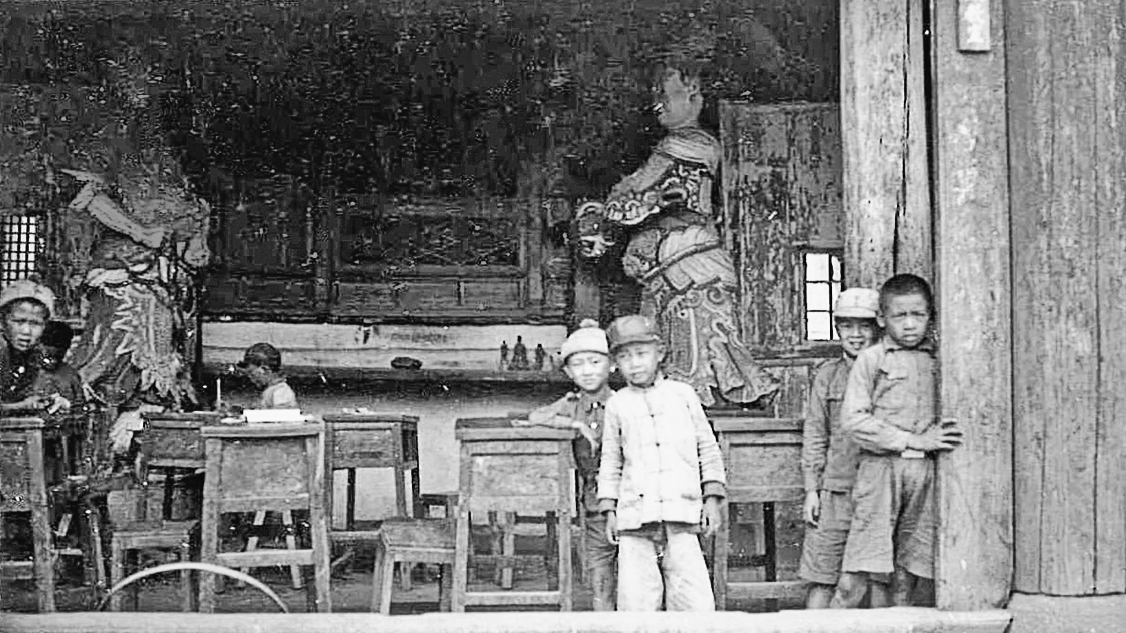 Chinese students in a partially destroyed school watching as our trucks went by