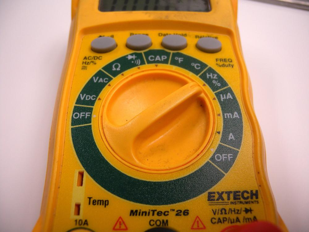 Use the multimeter’s dial to select the desired tool and measurement range.