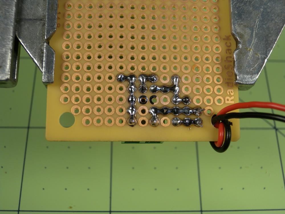 An alternative to making connections with wire is to create pseudotraces by bridging pads with a small amount of solder.